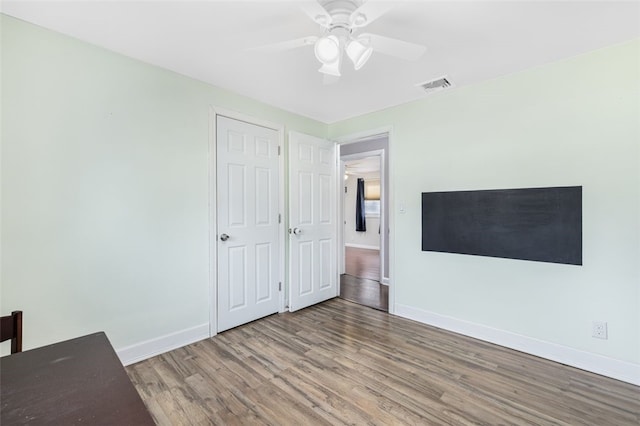 unfurnished bedroom featuring hardwood / wood-style flooring and ceiling fan