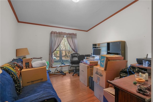 office space featuring lofted ceiling, hardwood / wood-style floors, and crown molding