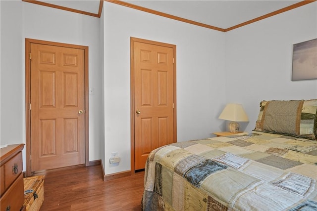 bedroom with dark hardwood / wood-style floors and ornamental molding