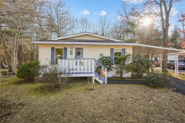 view of front of property with a front yard and a carport