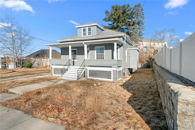 view of front of house featuring a porch and fence