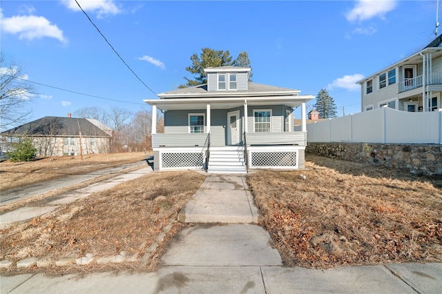 bungalow-style home with fence and a porch