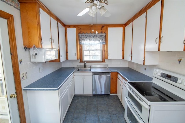 kitchen featuring tasteful backsplash, range with two ovens, white cabinets, stainless steel dishwasher, and sink