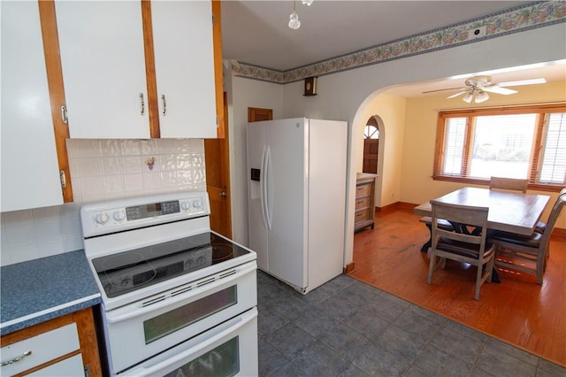 kitchen featuring ceiling fan, white appliances, white cabinets, and decorative backsplash