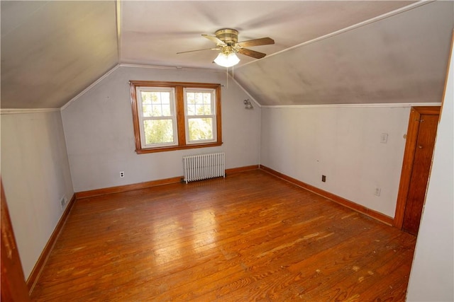 bonus room featuring light hardwood / wood-style flooring, ceiling fan, radiator, and lofted ceiling