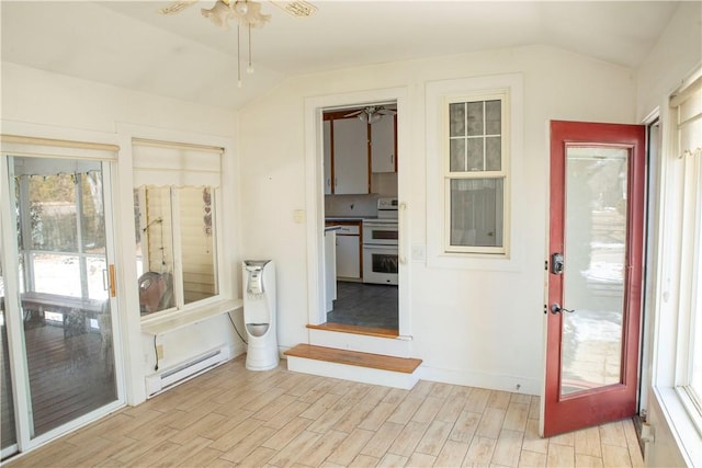 interior space with ceiling fan, light hardwood / wood-style floors, a baseboard radiator, and lofted ceiling