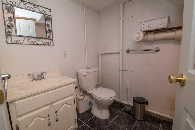 bathroom with vanity, tile patterned flooring, and toilet