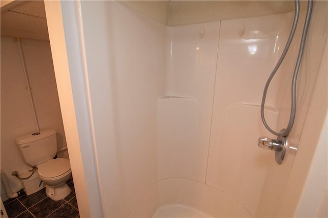 bathroom with toilet, tile patterned floors, and walk in shower