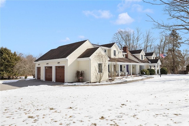 view of snow covered exterior featuring a garage