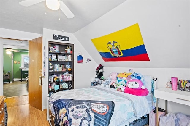 bedroom featuring ceiling fan, a baseboard radiator, wood-type flooring, and lofted ceiling