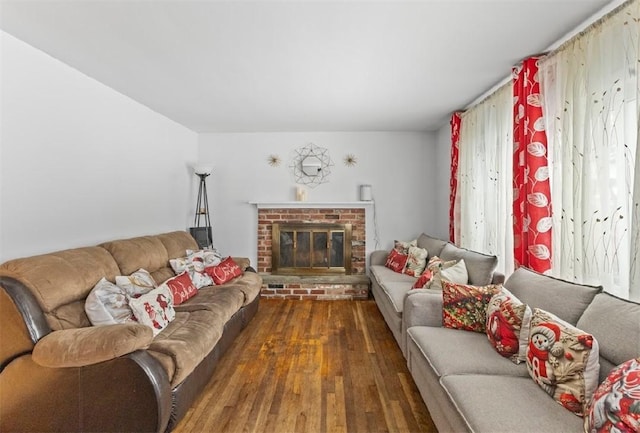 living room with a fireplace and dark wood-type flooring