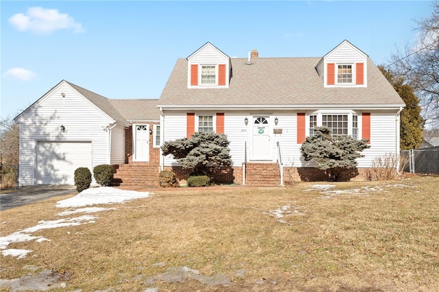 new england style home with a front yard and a garage