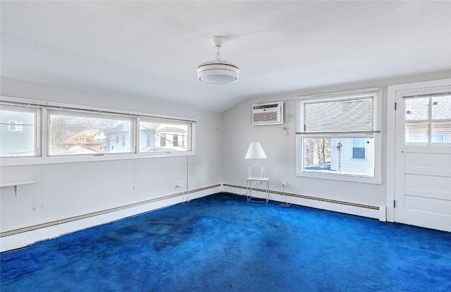 spare room featuring dark carpet, plenty of natural light, vaulted ceiling, and an AC wall unit