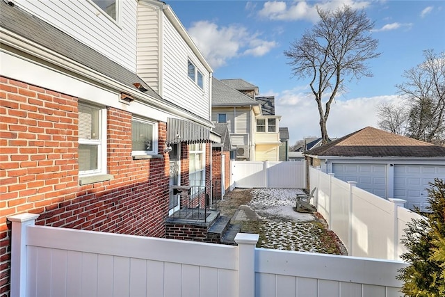 view of side of property with a garage and an outdoor structure