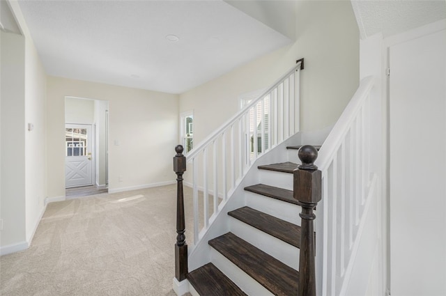 staircase with carpet flooring and baseboards