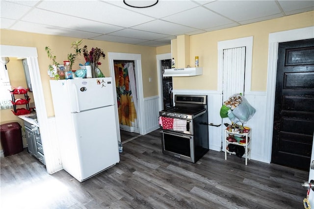 kitchen with a paneled ceiling, white refrigerator, dark hardwood / wood-style flooring, and stainless steel range with gas stovetop