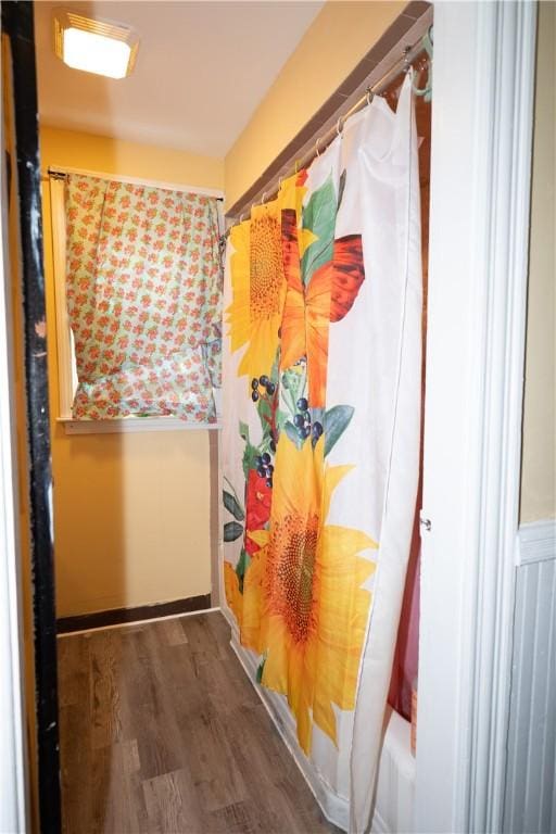 bathroom featuring hardwood / wood-style flooring and shower / tub combo