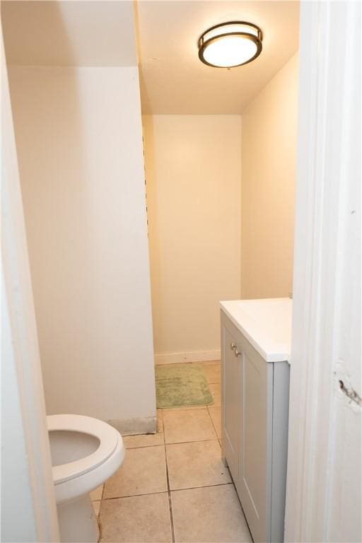 bathroom featuring toilet, tile patterned flooring, and vanity