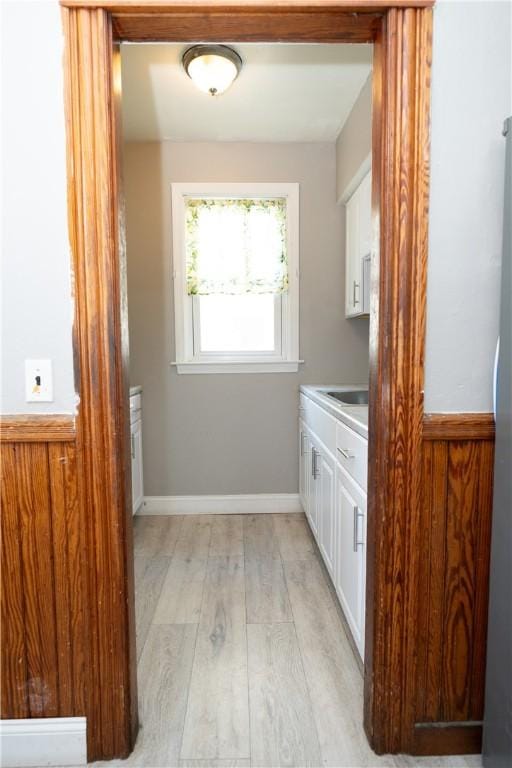 interior space with light hardwood / wood-style flooring and sink