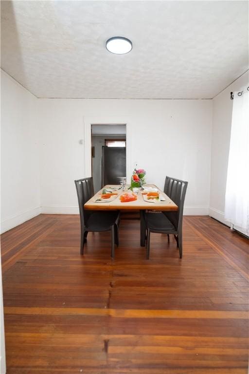 dining area with dark hardwood / wood-style floors