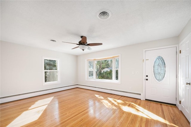 foyer featuring a textured ceiling, hardwood / wood-style floors, and ceiling fan