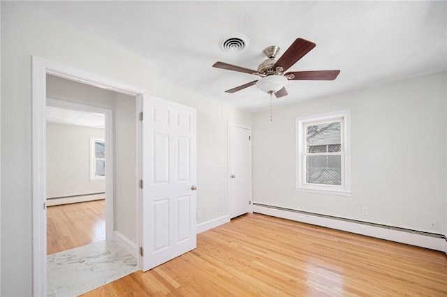 unfurnished bedroom with ceiling fan, light wood-type flooring, and a baseboard radiator