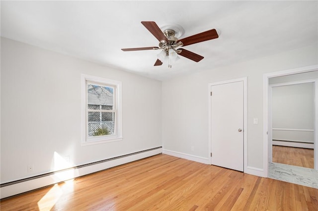 unfurnished room with ceiling fan, light hardwood / wood-style flooring, and a baseboard radiator