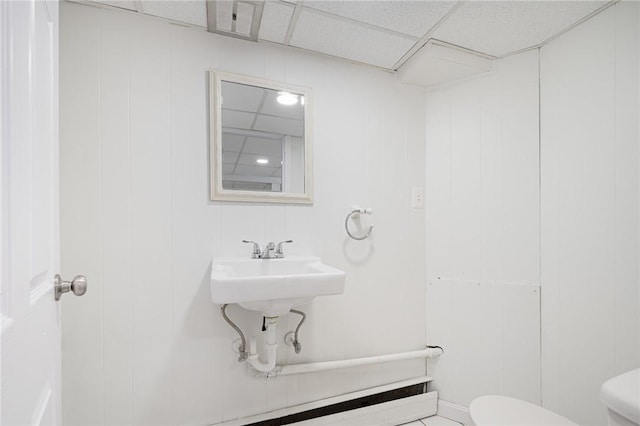 bathroom with a drop ceiling and toilet