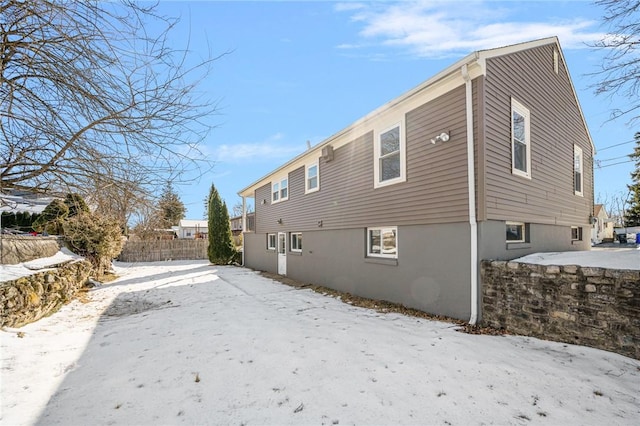 view of snow covered rear of property