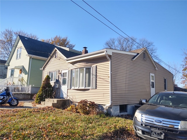 view of property exterior with a chimney