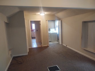 additional living space featuring vaulted ceiling, carpet flooring, baseboards, and washing machine and dryer