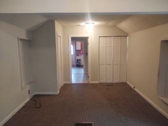 additional living space featuring lofted ceiling, carpet flooring, and baseboards