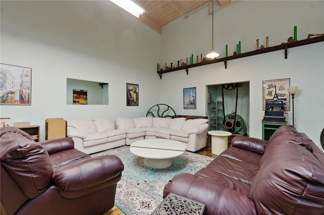 living room featuring high vaulted ceiling, hardwood / wood-style floors, and beamed ceiling