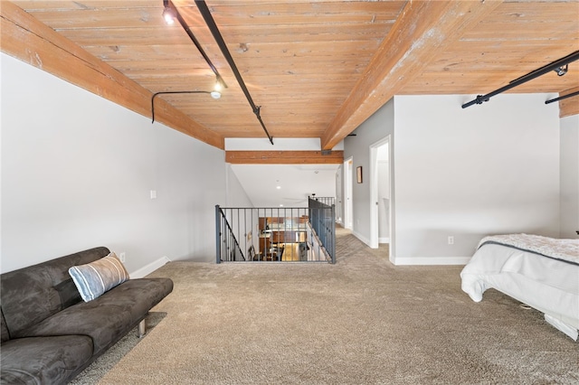 interior space with track lighting, beamed ceiling, and wood ceiling