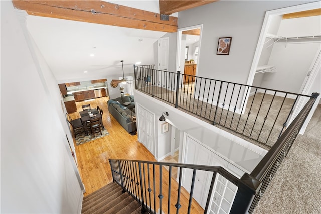 staircase featuring ceiling fan and wood-type flooring