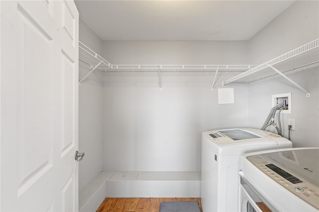 laundry area featuring hardwood / wood-style floors and washer and clothes dryer