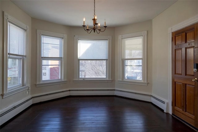 unfurnished dining area with a notable chandelier, dark wood-type flooring, and a baseboard heating unit