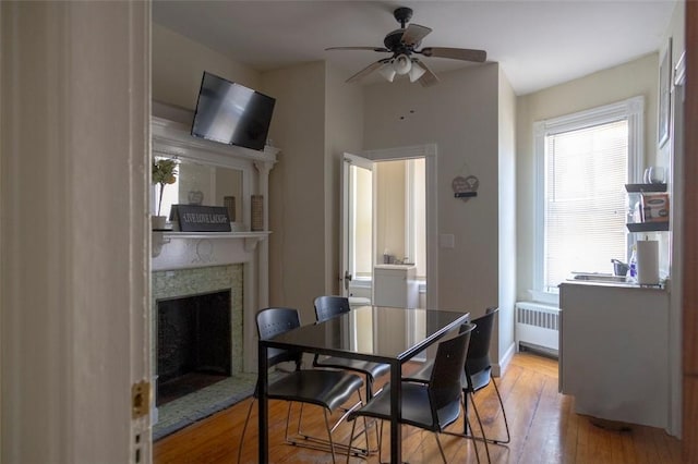 dining area featuring radiator, ceiling fan, and light hardwood / wood-style floors