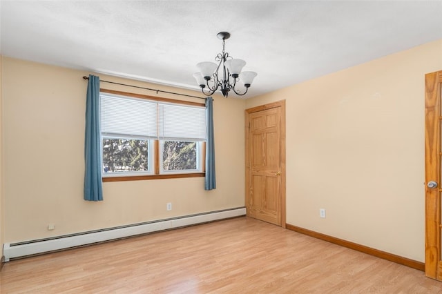 unfurnished room with baseboard heating, light hardwood / wood-style floors, and a notable chandelier