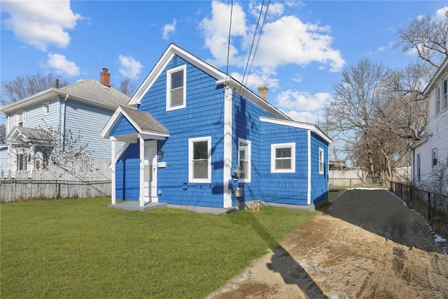 rear view of house featuring a yard