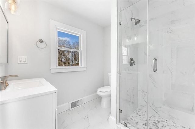 bathroom with toilet, an enclosed shower, and vanity