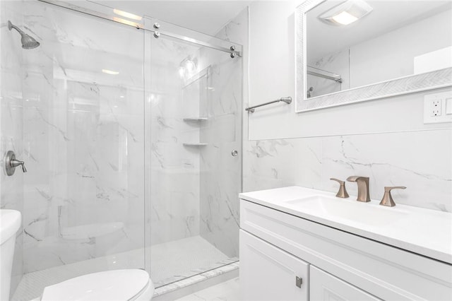 bathroom featuring tile walls, toilet, a shower with door, and vanity