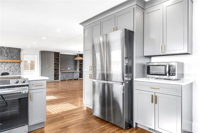 kitchen featuring gray cabinets, hardwood / wood-style floors, and stainless steel appliances