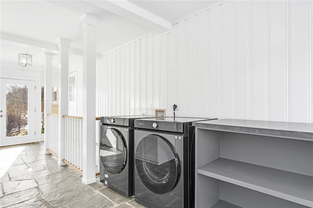 clothes washing area with independent washer and dryer and ornate columns