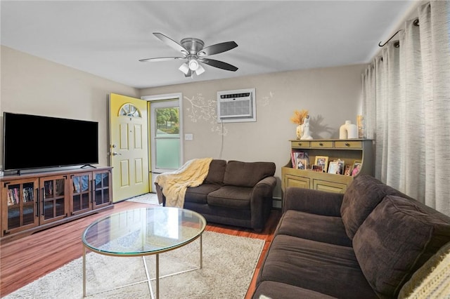 living room featuring an AC wall unit, hardwood / wood-style flooring, and ceiling fan