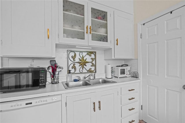 kitchen featuring sink, dishwasher, and white cabinets