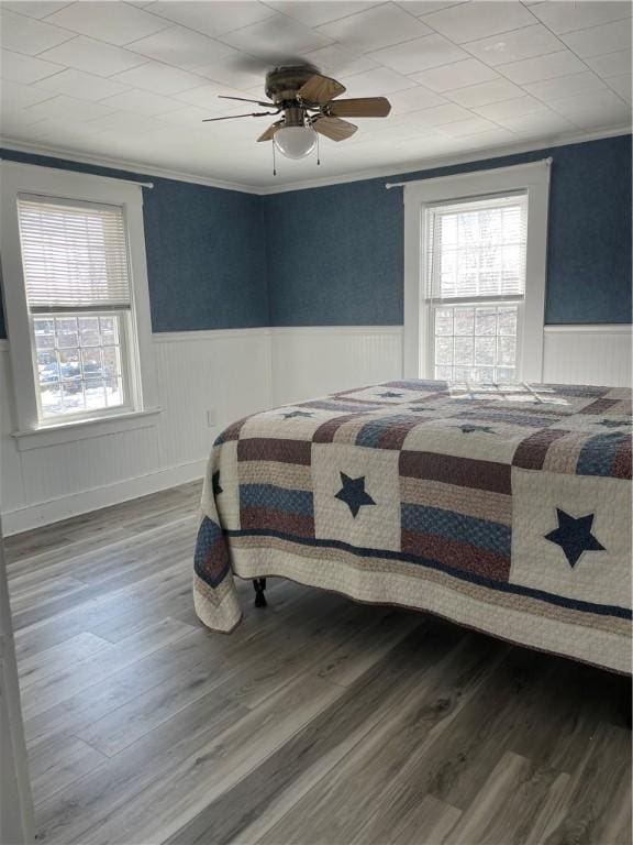 840 S Main St, Burrillville, RI 02859 - bedroom with multiple windows, wood finished floors, wainscoting, ornamental molding, and ceiling fan
