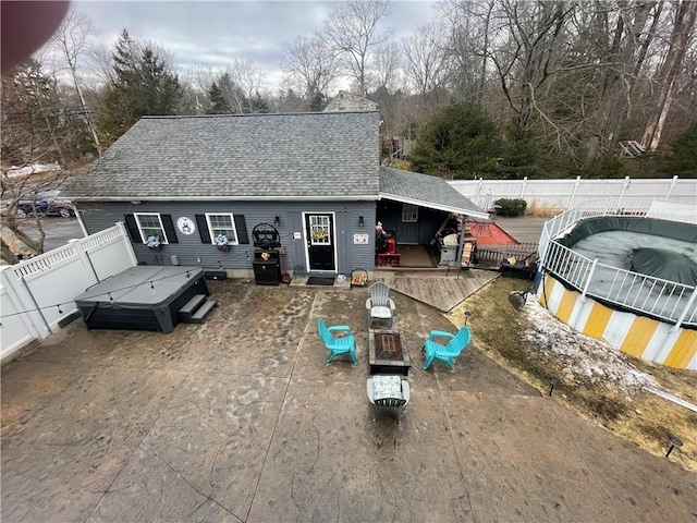 840 S Main St, Burrillville, RI 02859 - rear view of house with a hot tub, roof with shingles, a fenced backyard, a deck, and a patio area