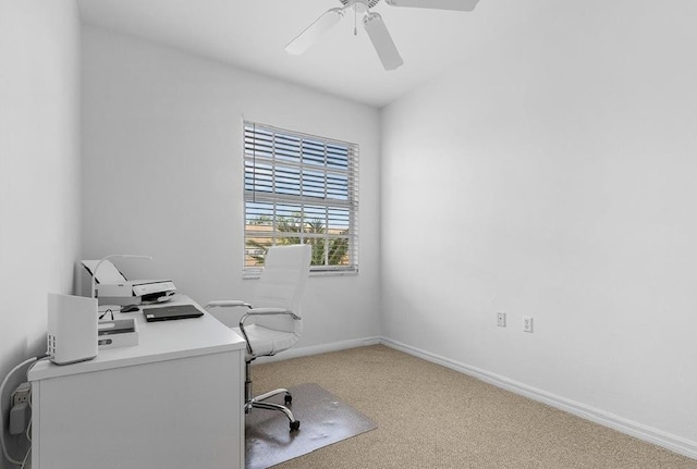 carpeted home office featuring ceiling fan