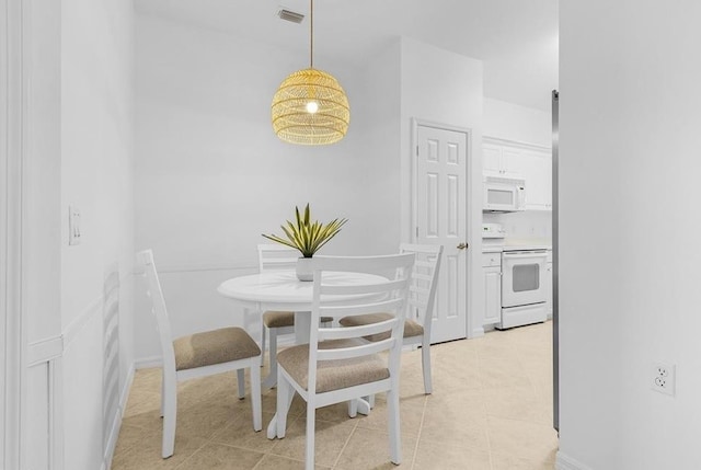 dining space with light tile patterned floors